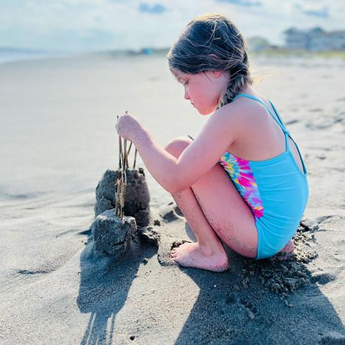 “My granddaughter Esther loves the beach and becomes very creative with her sand art! Photo was taken on Emerald Isle by her mother Kerri.” —Shirley Brutko, Kings Mountain, Rutherford EMC